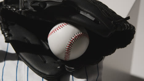 Handheld-Close-Up-Studio-Baseball-Still-Life-With-Ball-Catchers-Mitt-And-Team-Jersey-1